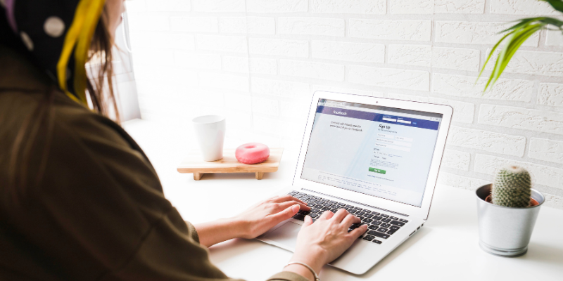 woman laptop facebook